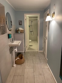 The shower at the end of the restaurant toilet. (The basket beside the sink was overflowing with dirty towels that stayed overnight, and were still there when we went to shower the next AM.