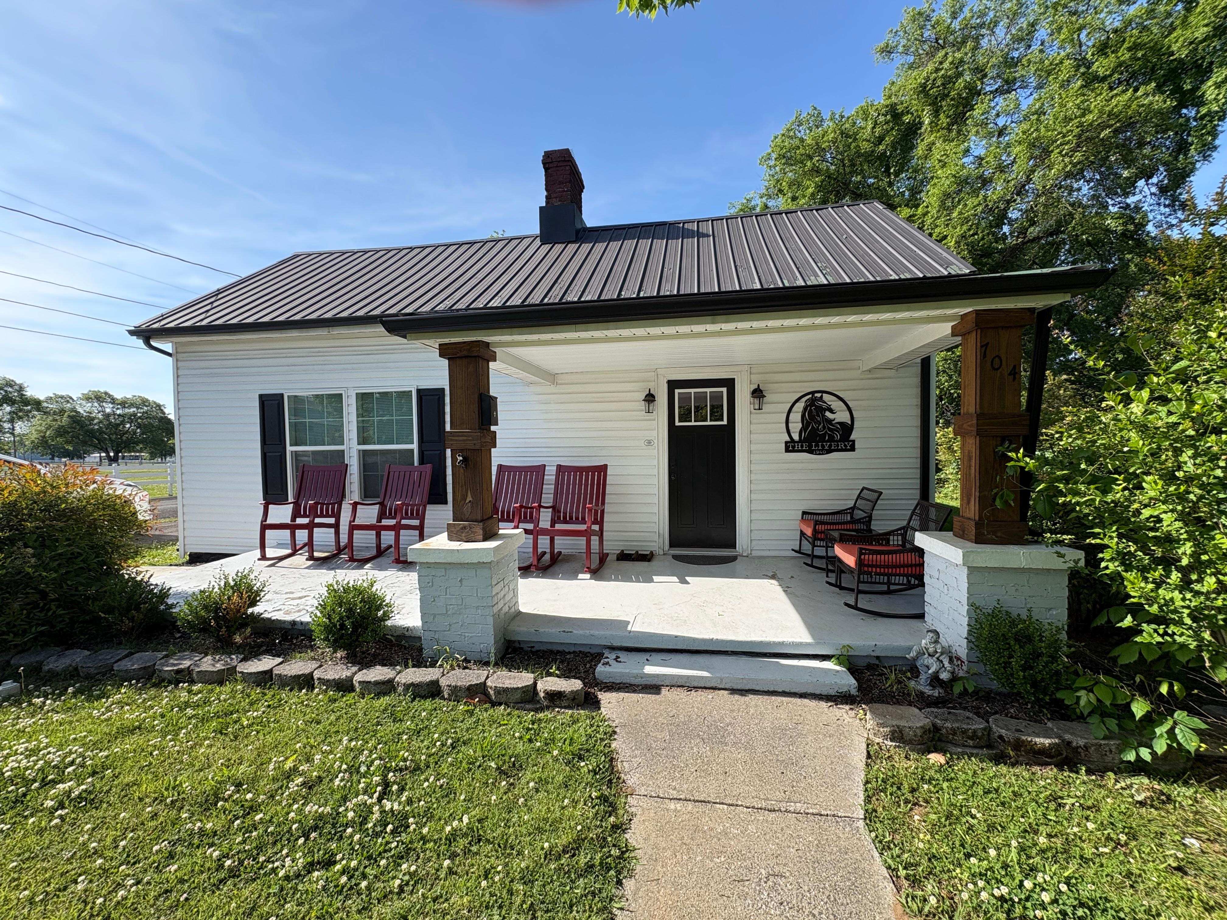 front of home and porch with rocking chairs 