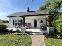 front of home and porch with rocking chairs