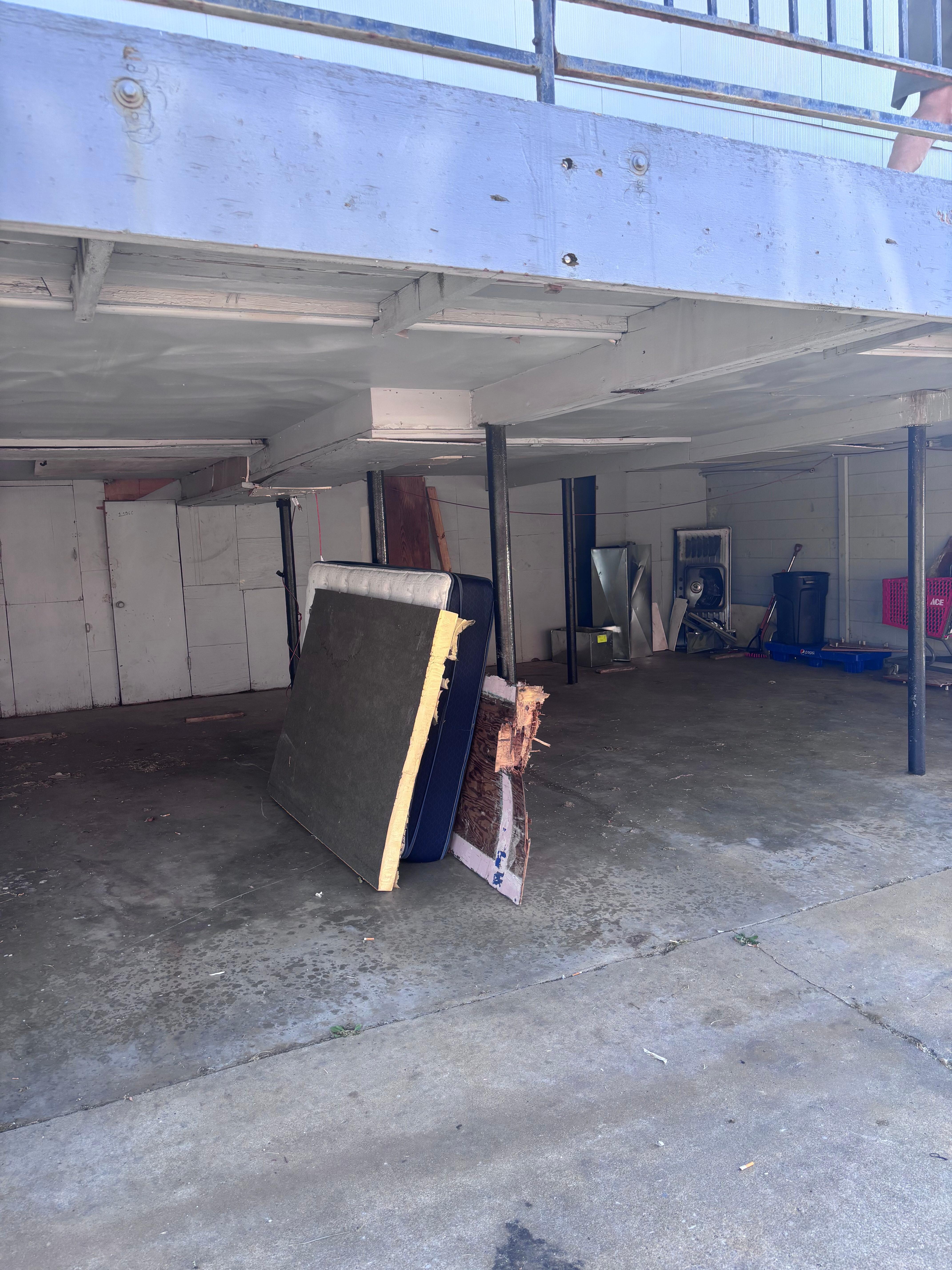 dirty mattresses and garbage in the parking area