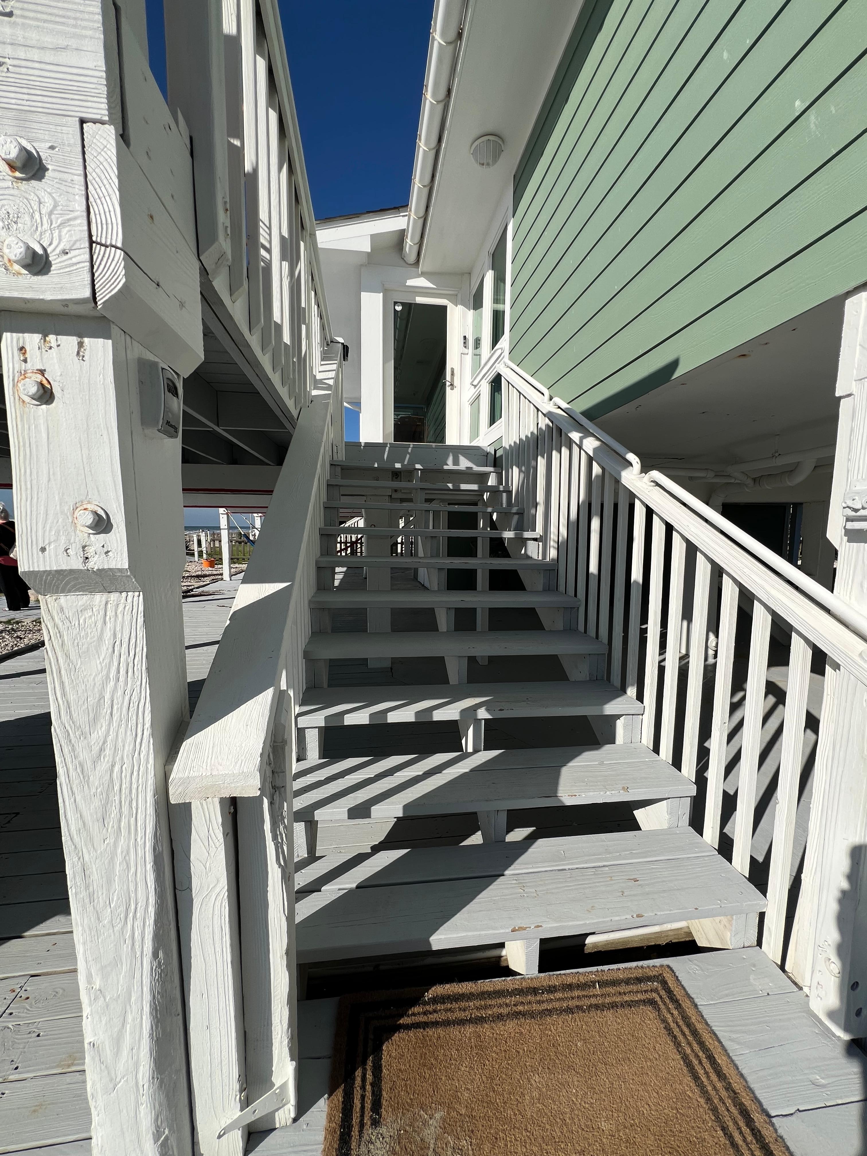 The stairs to get to the deck to enter the property 