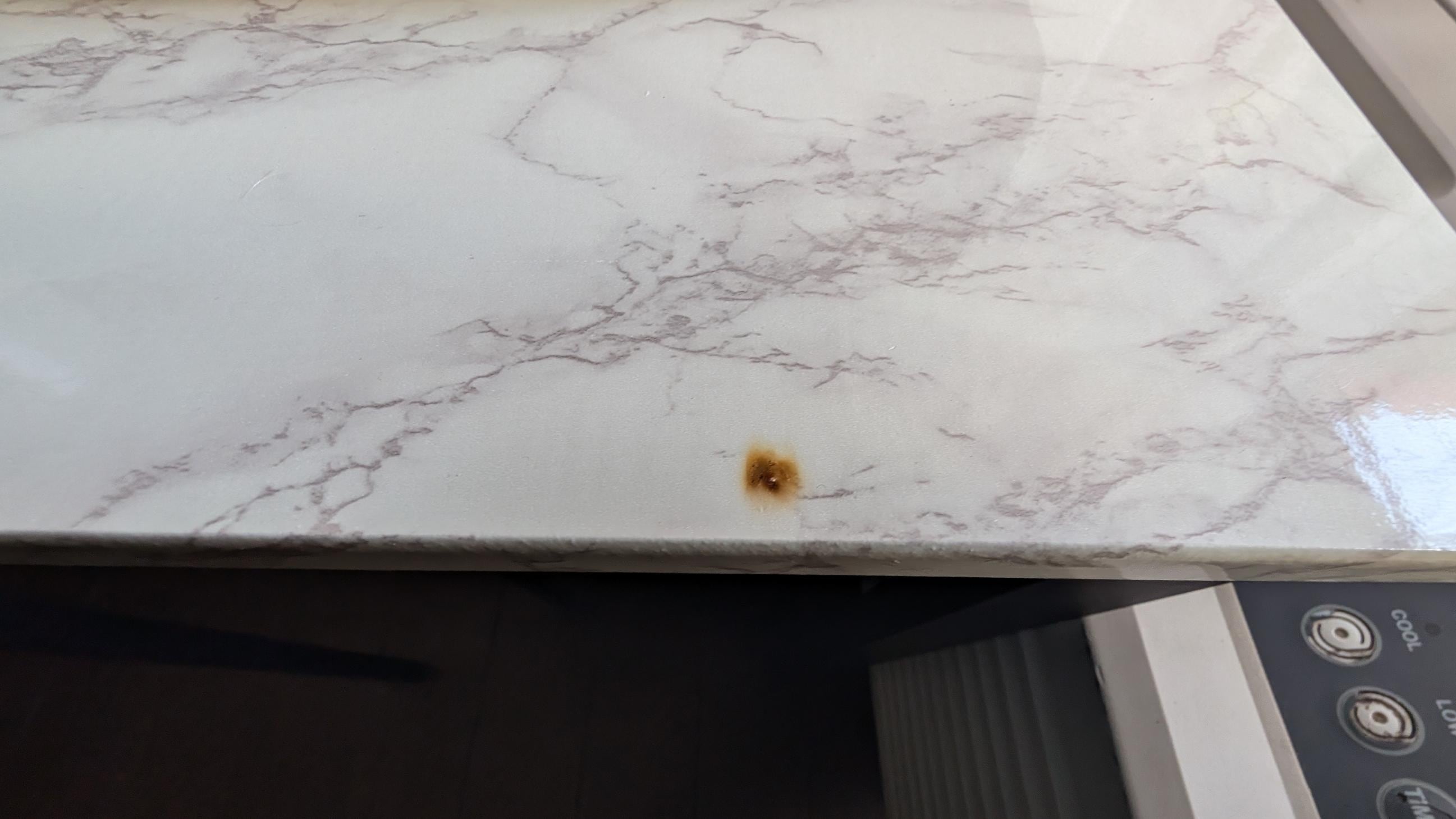 Cigarette burns on kitchen table