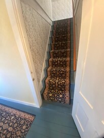Open the door and start climbing the stairs