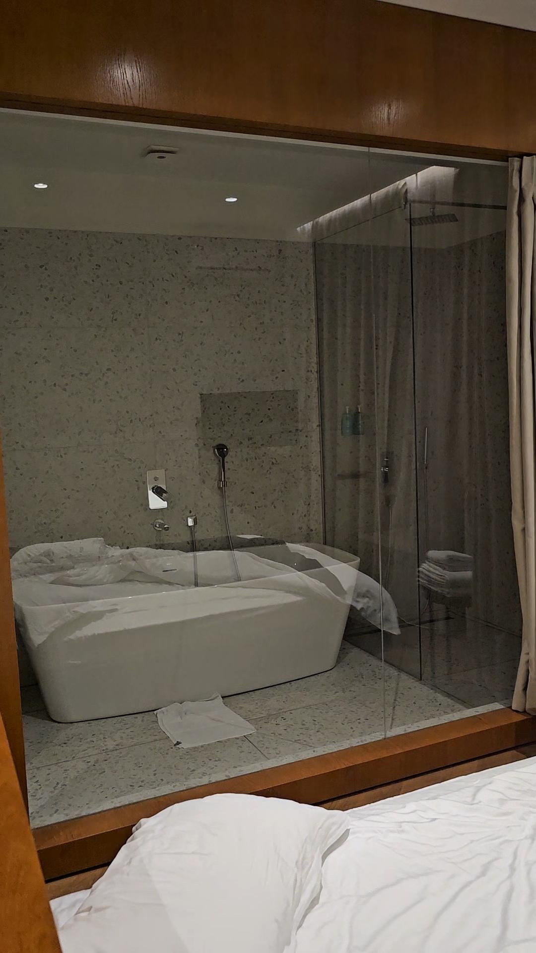 Lovely spacious bathroom with a large bath tub and also a walk in shower.