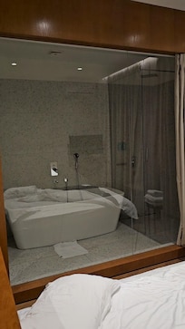 Lovely spacious bathroom with a large bath tub and also a walk in shower.