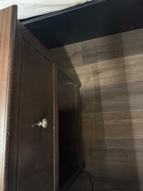 Room floor cracked and caving down by the nightstand