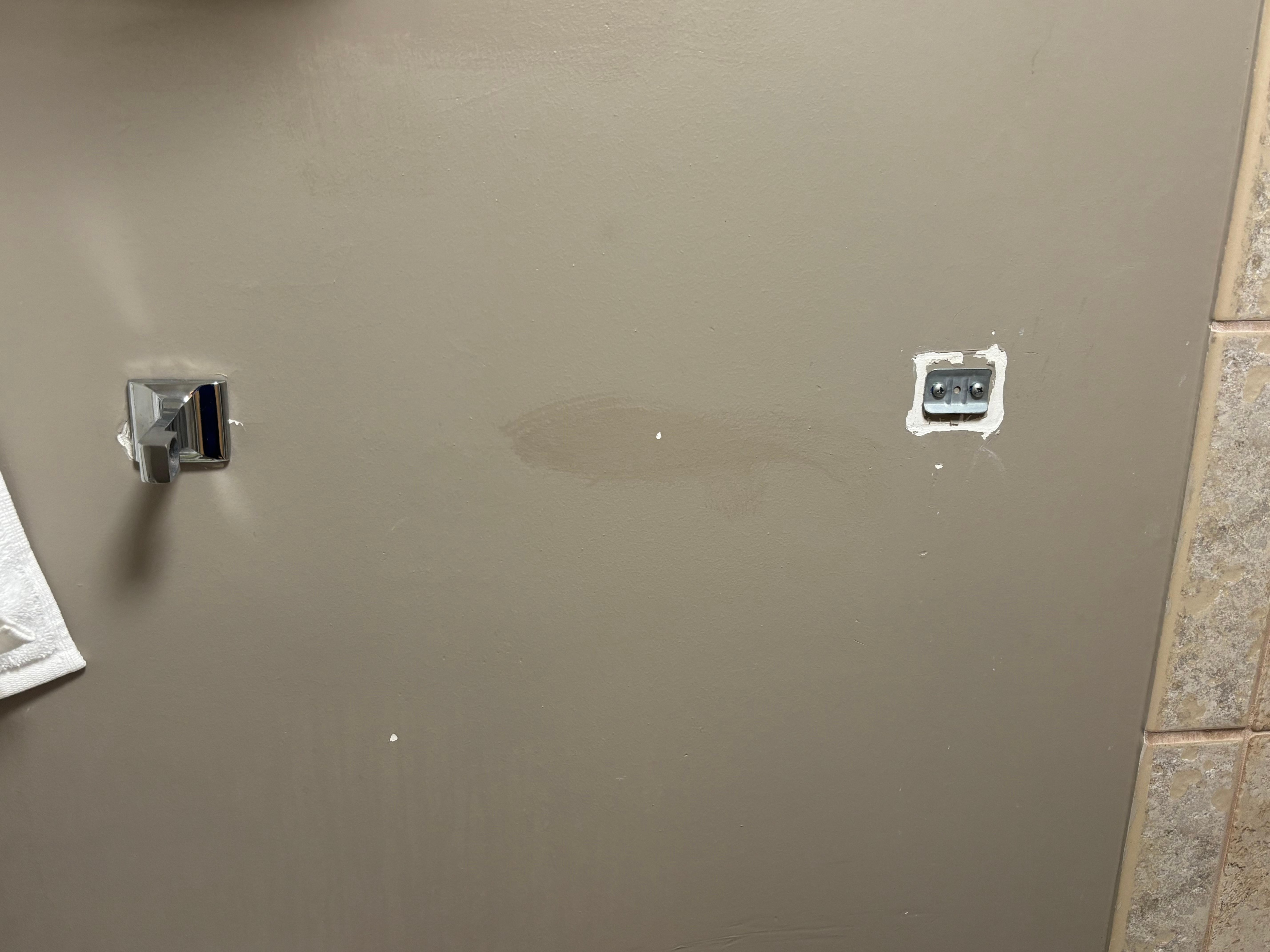 The towel rod next to the shower was missing. Appeared to have been damaged and never repaired. 