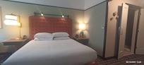 Comfy king size bed and nice clean bathroom with a shower.