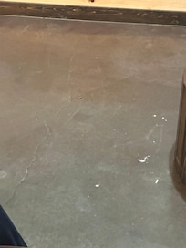 Trash in common are edge of coffee table