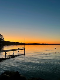 Sunset over the lake with ducks on the dock