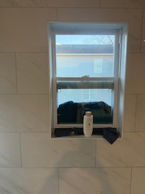 Upstairs shower with window. Used a towel to try to block the view.