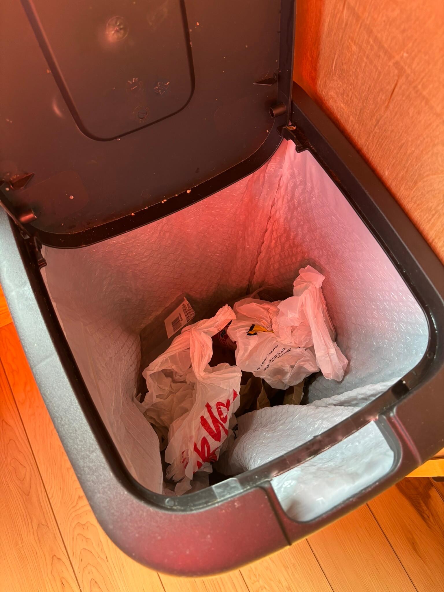 All three kitchen garbage cans had trash in them, from previous tenants.