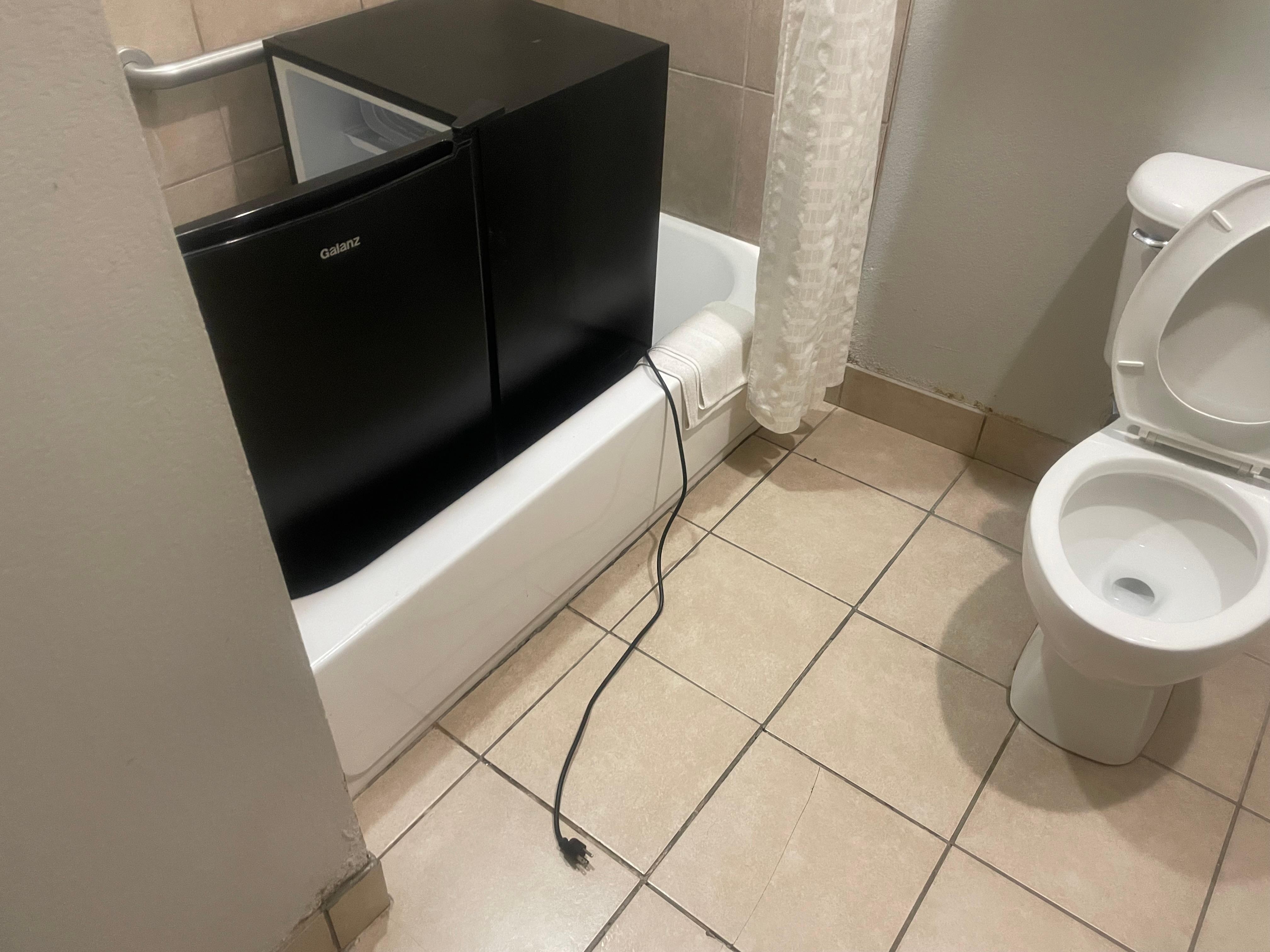 Fridge left in the shower by the staff.