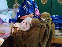 Mum sitting in a “hot” as owner described room