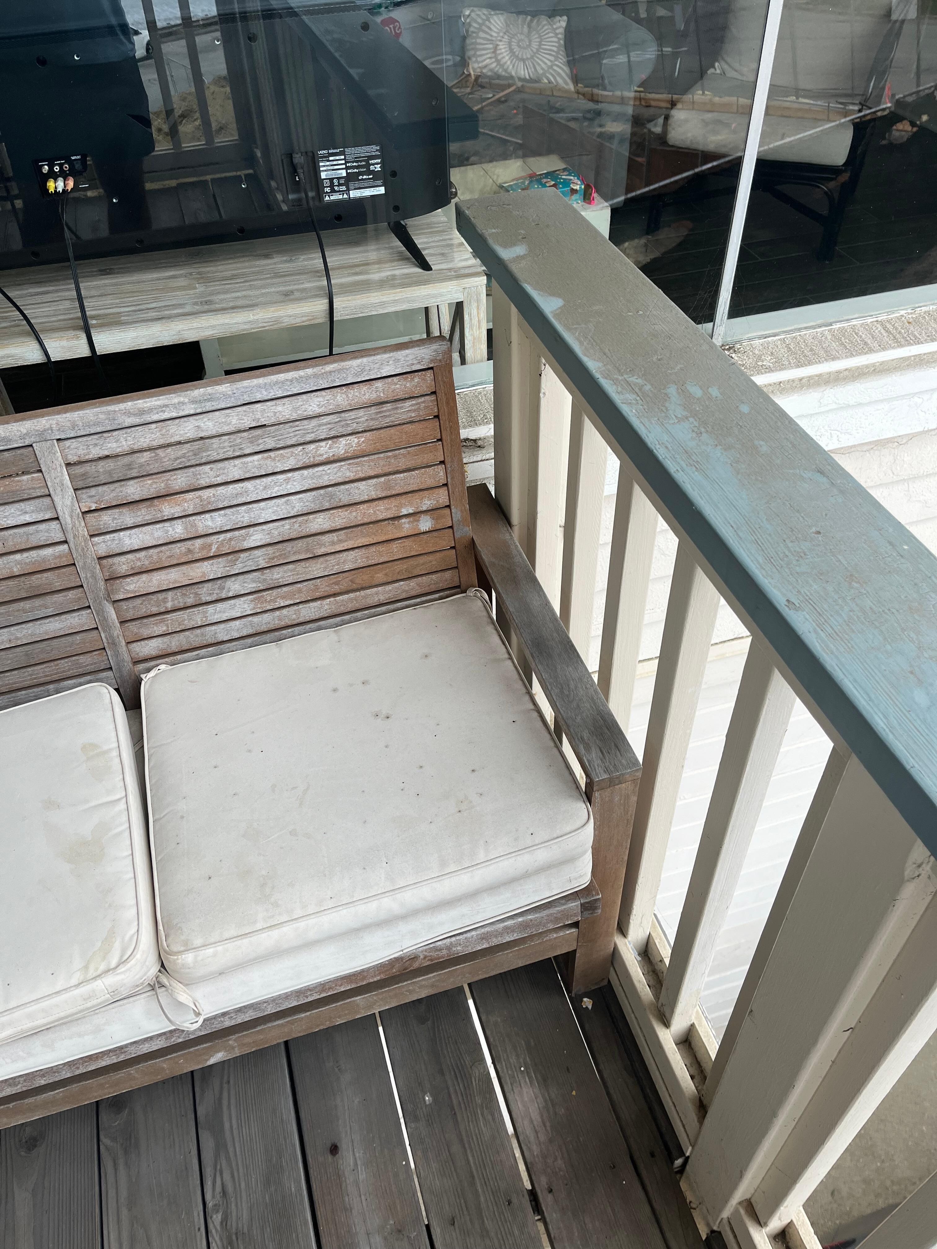 Patio furniture has mold and railings dirt. 