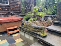The hot tub area and a reclining buddha