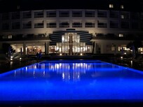 Hotel pool side, evening.