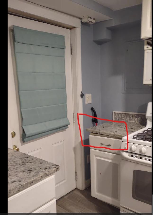 Uneven countertop. Cabinet prevents entry door from opening fully.