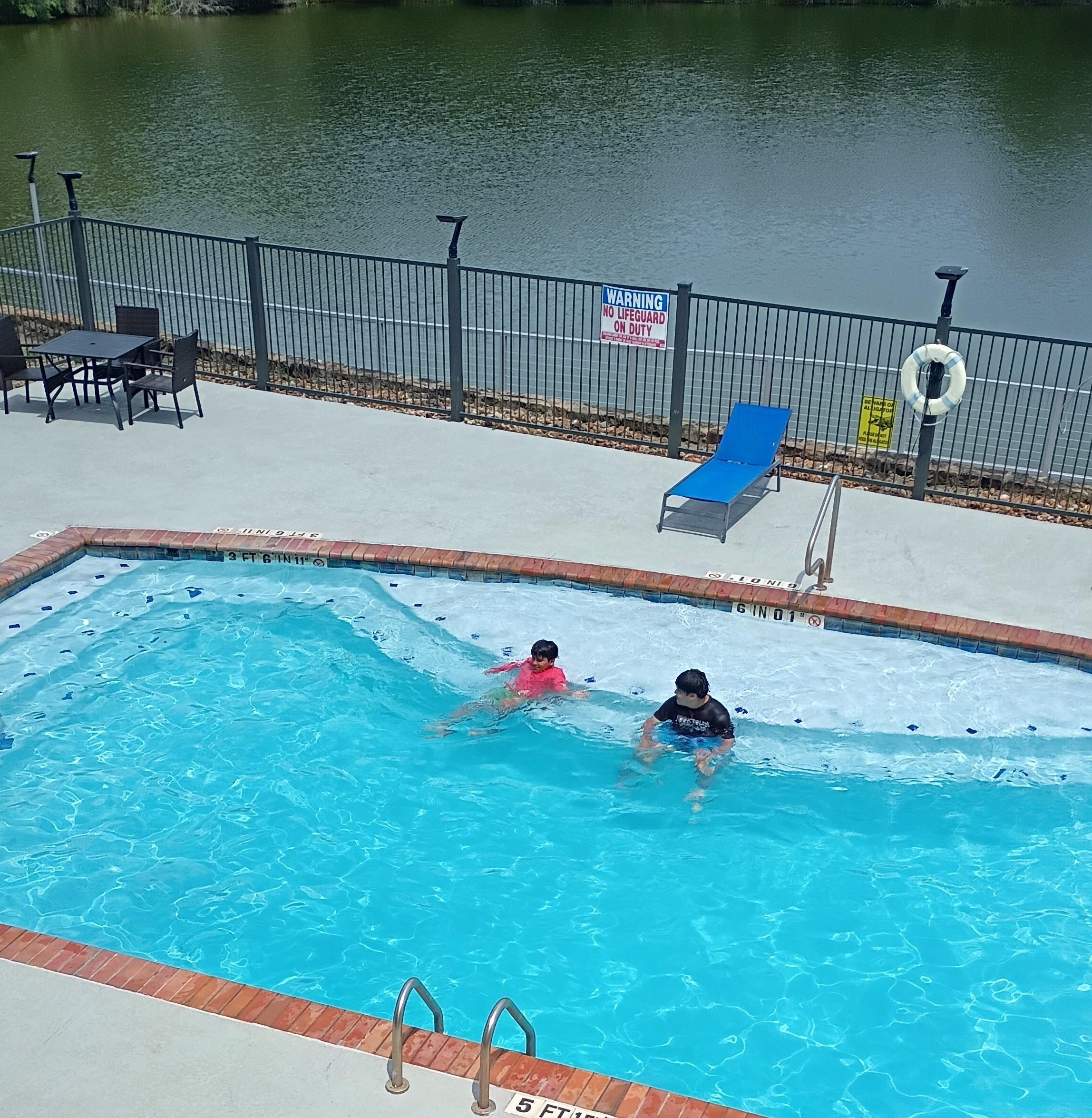 Pool next to a lake. 