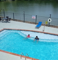 Pool next to a lake.