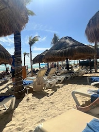 Beach loungers - staff brings you drinks and food. Tip each time you get something.