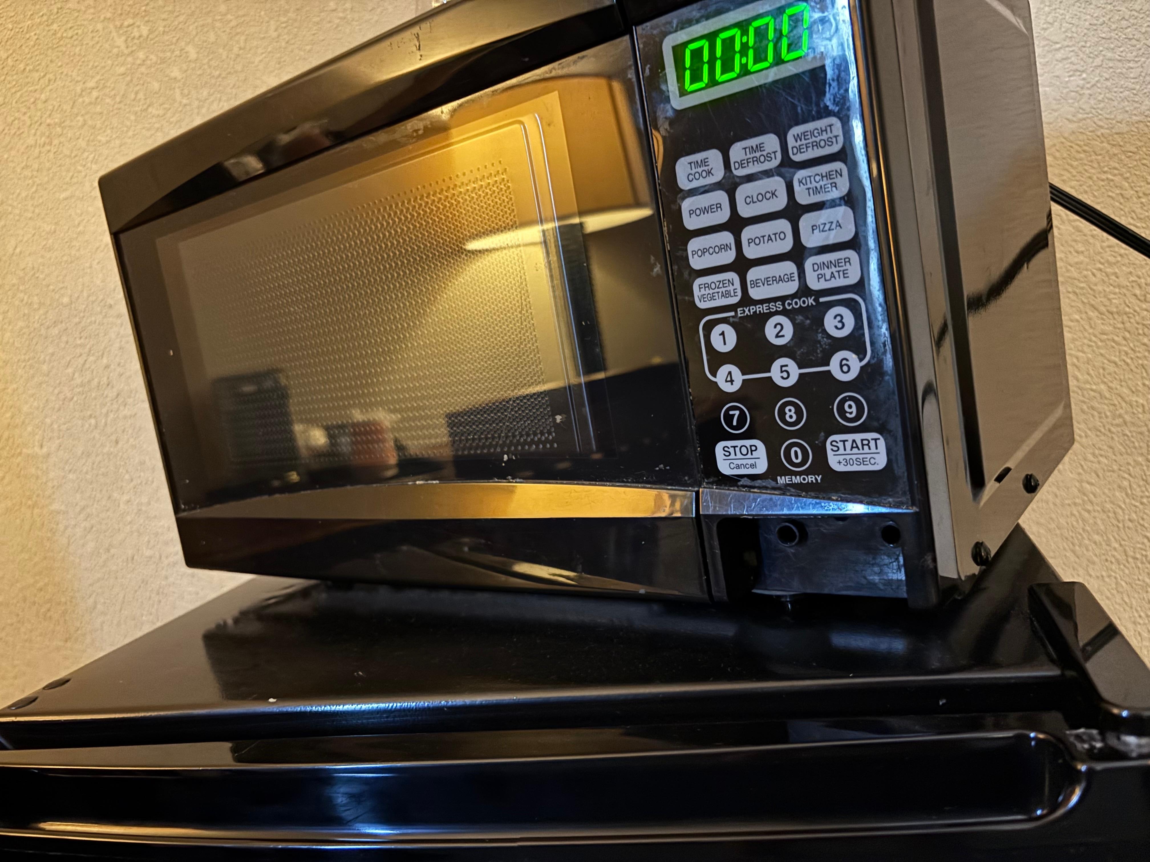 the microwave is on but you can’t press the button to open it lol it’s missing and can’t access it