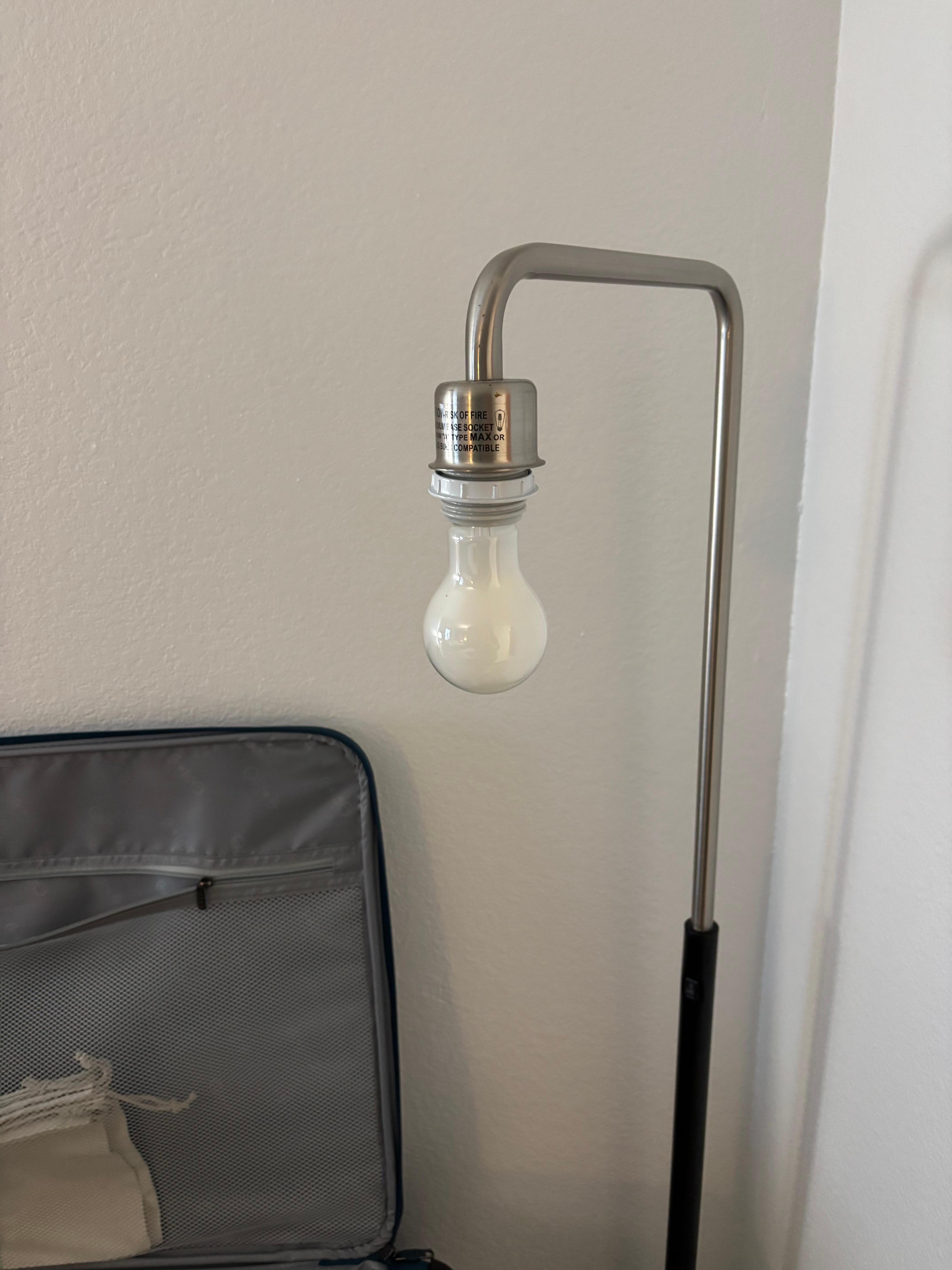 The lamp with the missing lampshade.