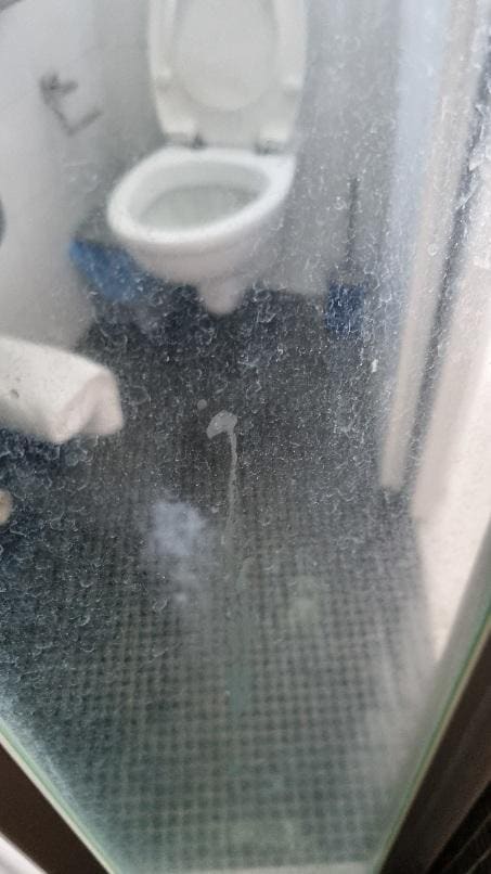 Dirty glass door in shower
