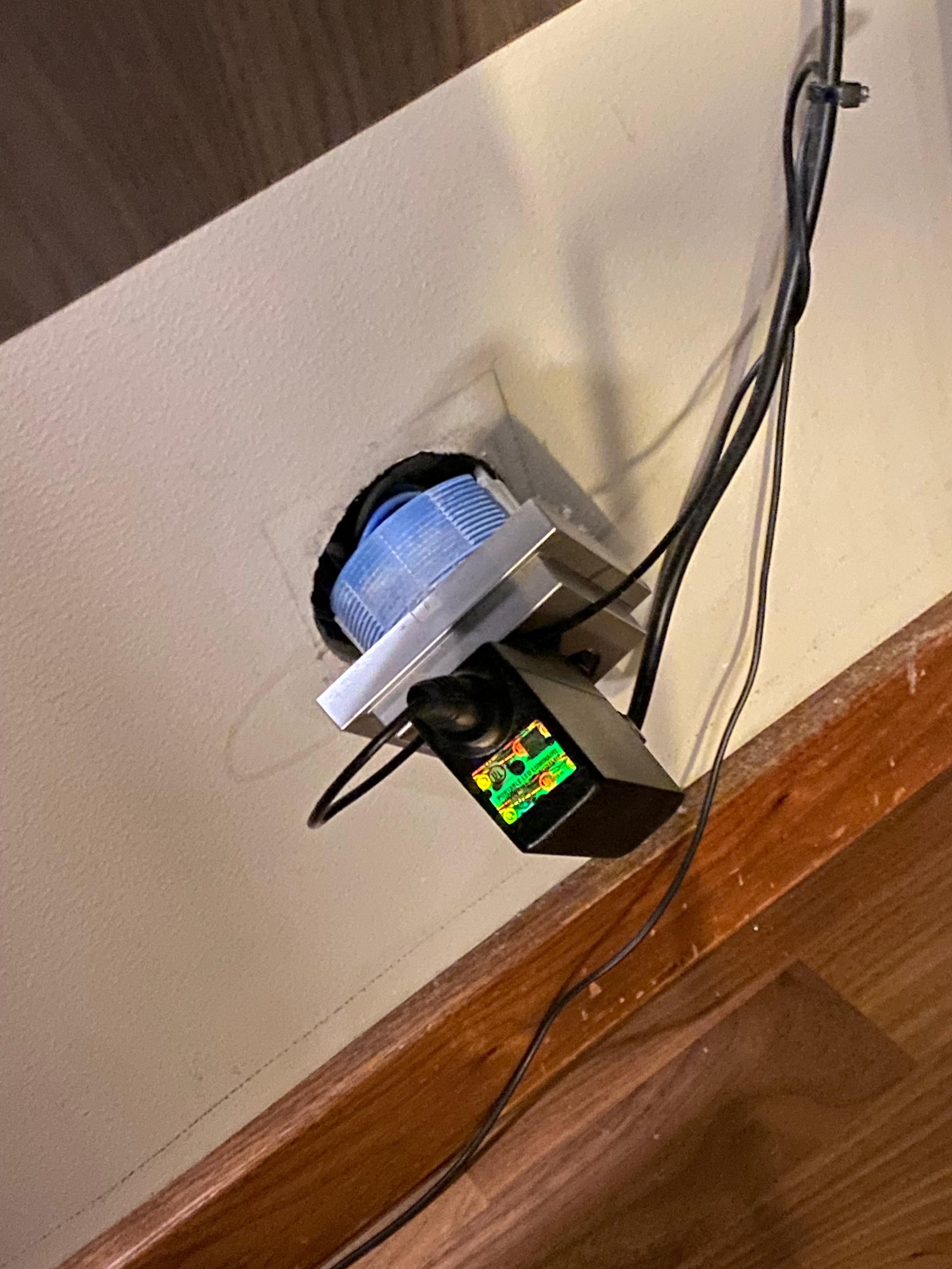 Electrical plug off the wall under the tiny table