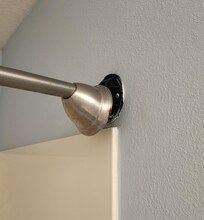 Shower rod caps & rod barely holding on.