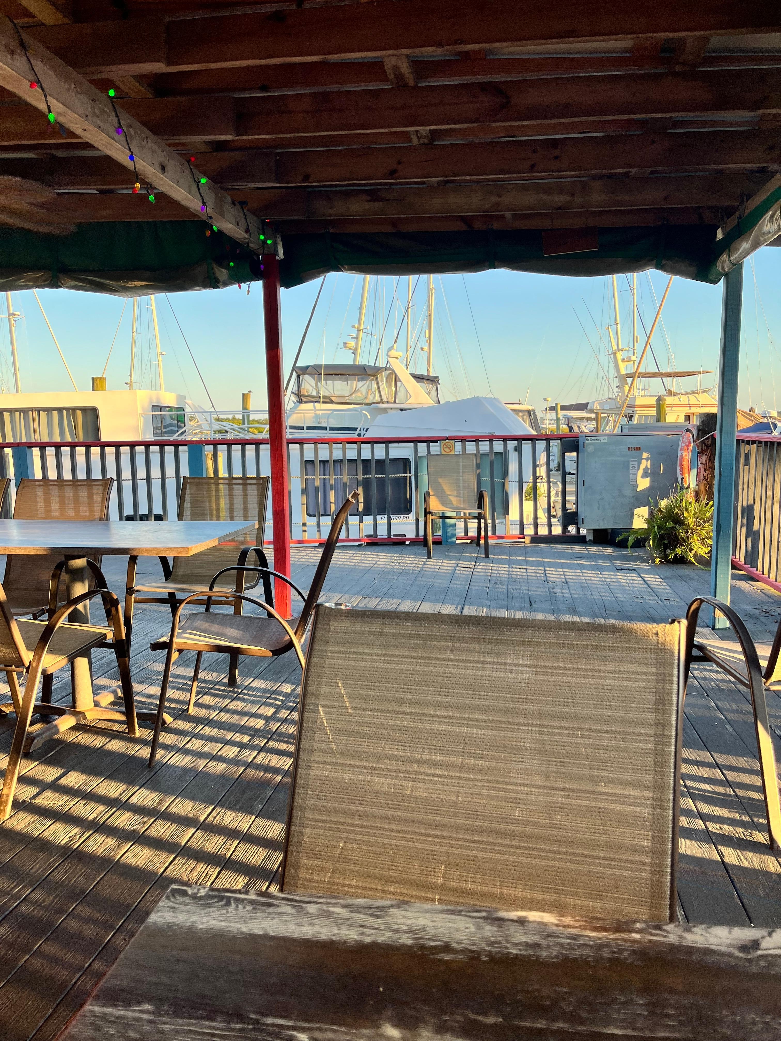 Very close place to eat. Sitting at table with boat in view. 