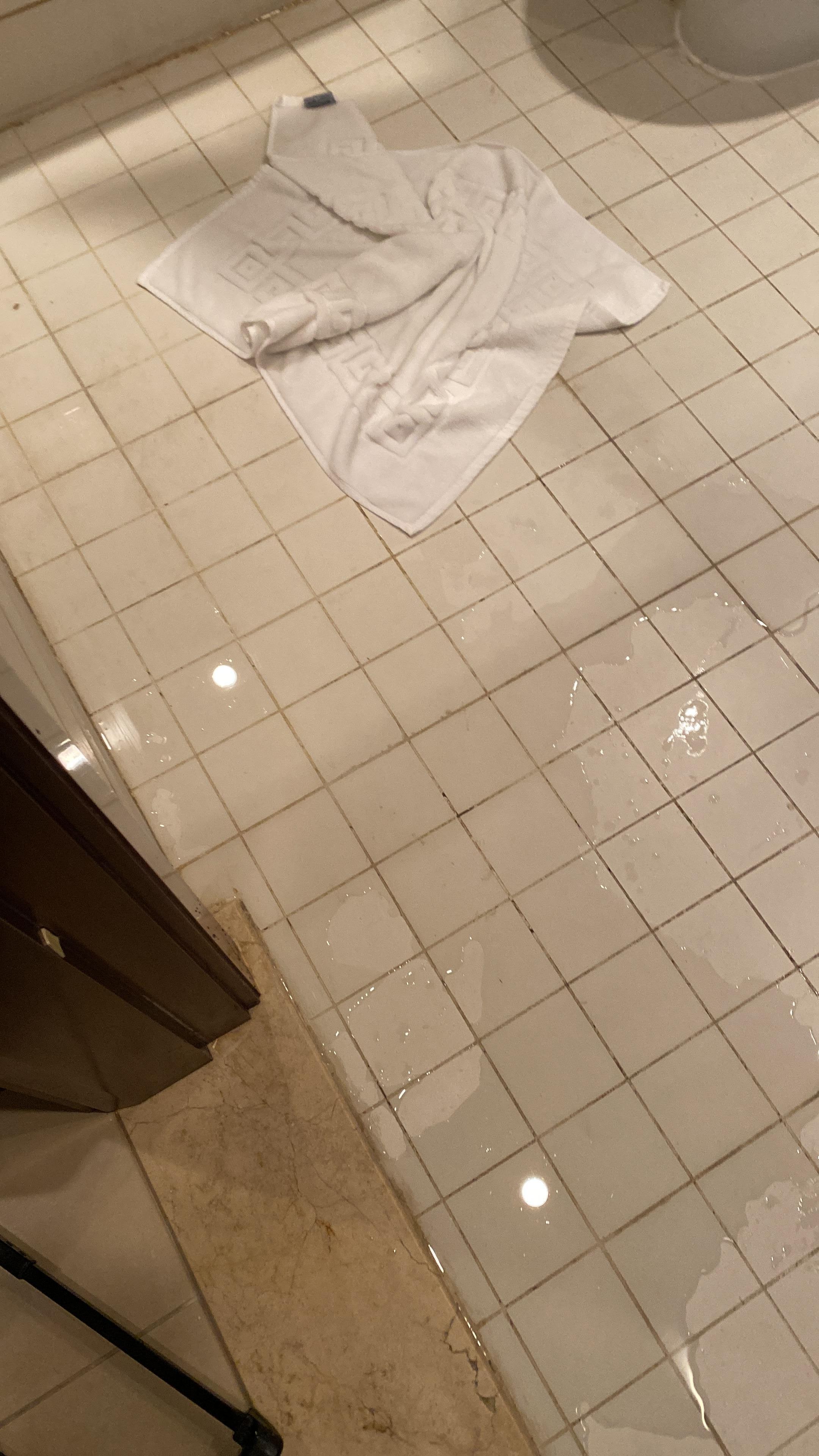 Clogged bathtub and flooded bathroom floor