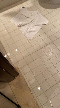 Clogged bathtub and flooded bathroom floor