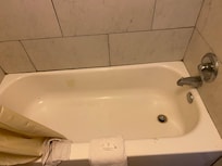 Hair on tub and a black dirty tub