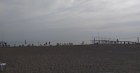 View of the spacious private beach with sunchairs and beach volleyball.