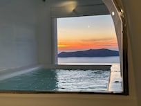 View from the room past the private heated tub open to the sunset