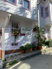 Darrussaade Hotel entrance surrounded by greenery and fragrant flowers all around.
