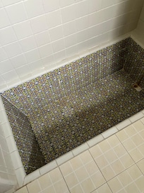This is bizarre 2 feet deep pit you stand in while taking a shower