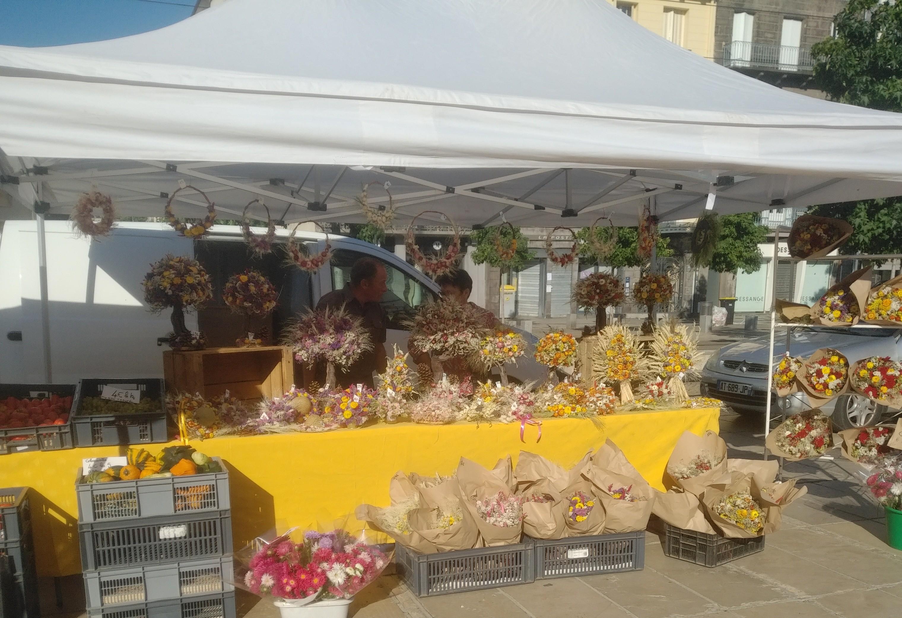 Variety of food and flower stalls on Sunday market. 