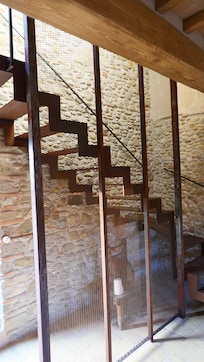 Modern meets ancient. Core-ten steel staircase delivers you to the first floor….2nd story to Americans!