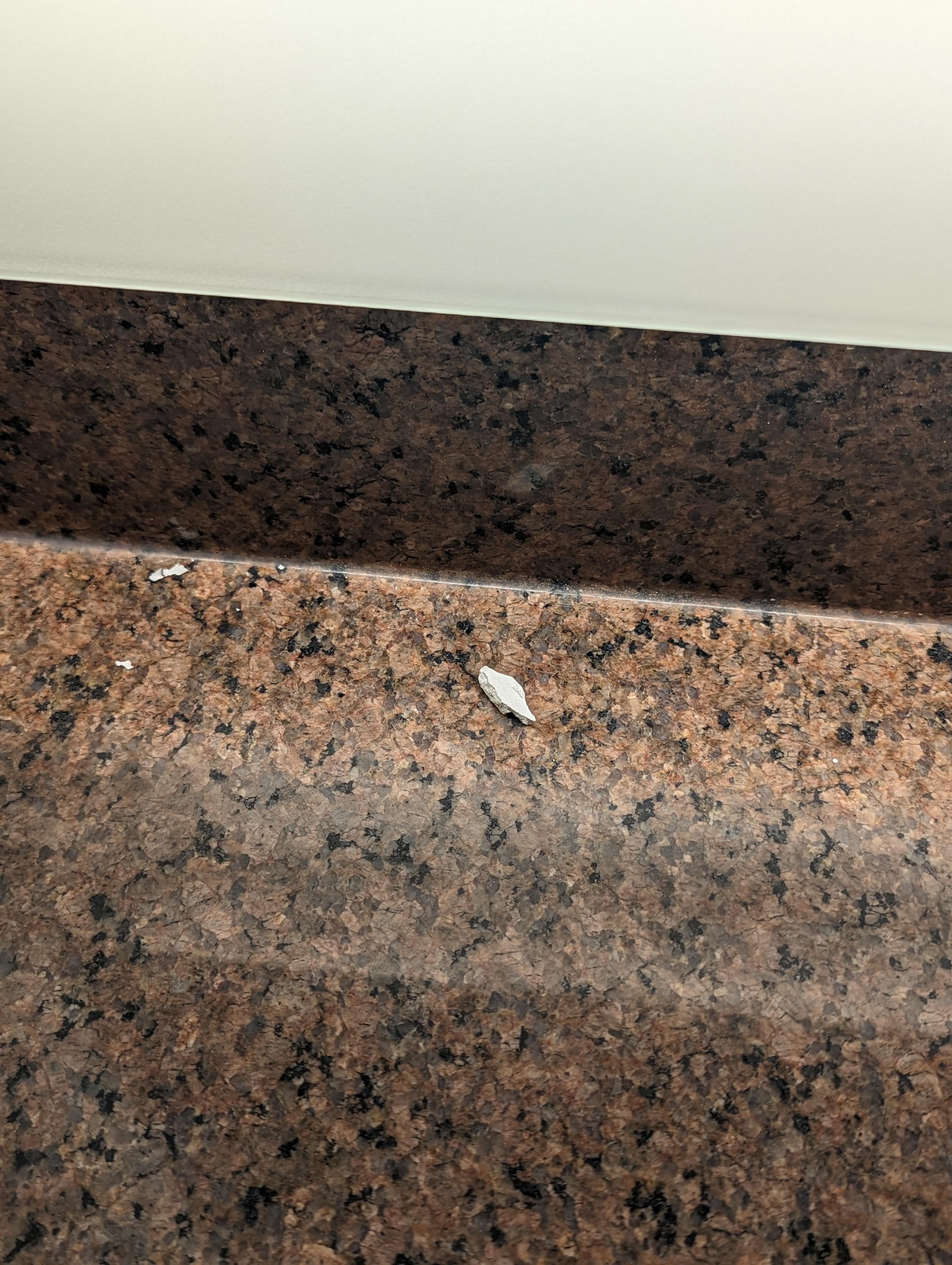 Chipped plaster on the sink