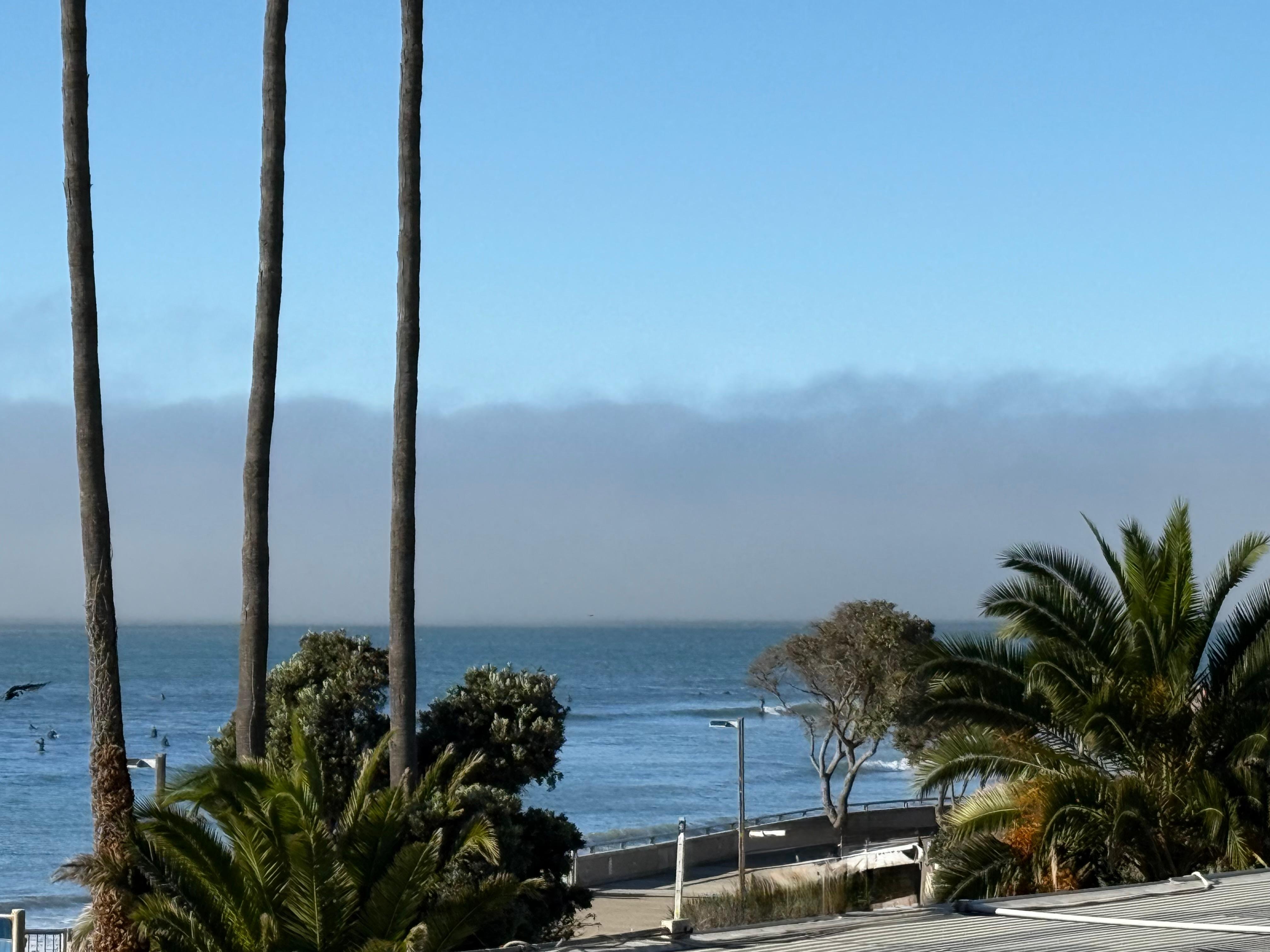 Lots of surfers and walkway to stroll along the beach