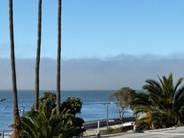 Lots of surfers and walkway to stroll along the beach