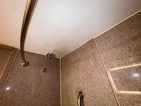Water damage/unfinished drywall repair in bathroom.