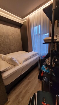 Queen bed surrounded by walls.