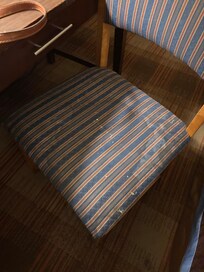 Piss stain small pebbles on the seat. Dirty chair
The room smelled like sweaty feet