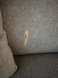 Burn on the sofa (covered by a pillow when we arrived)