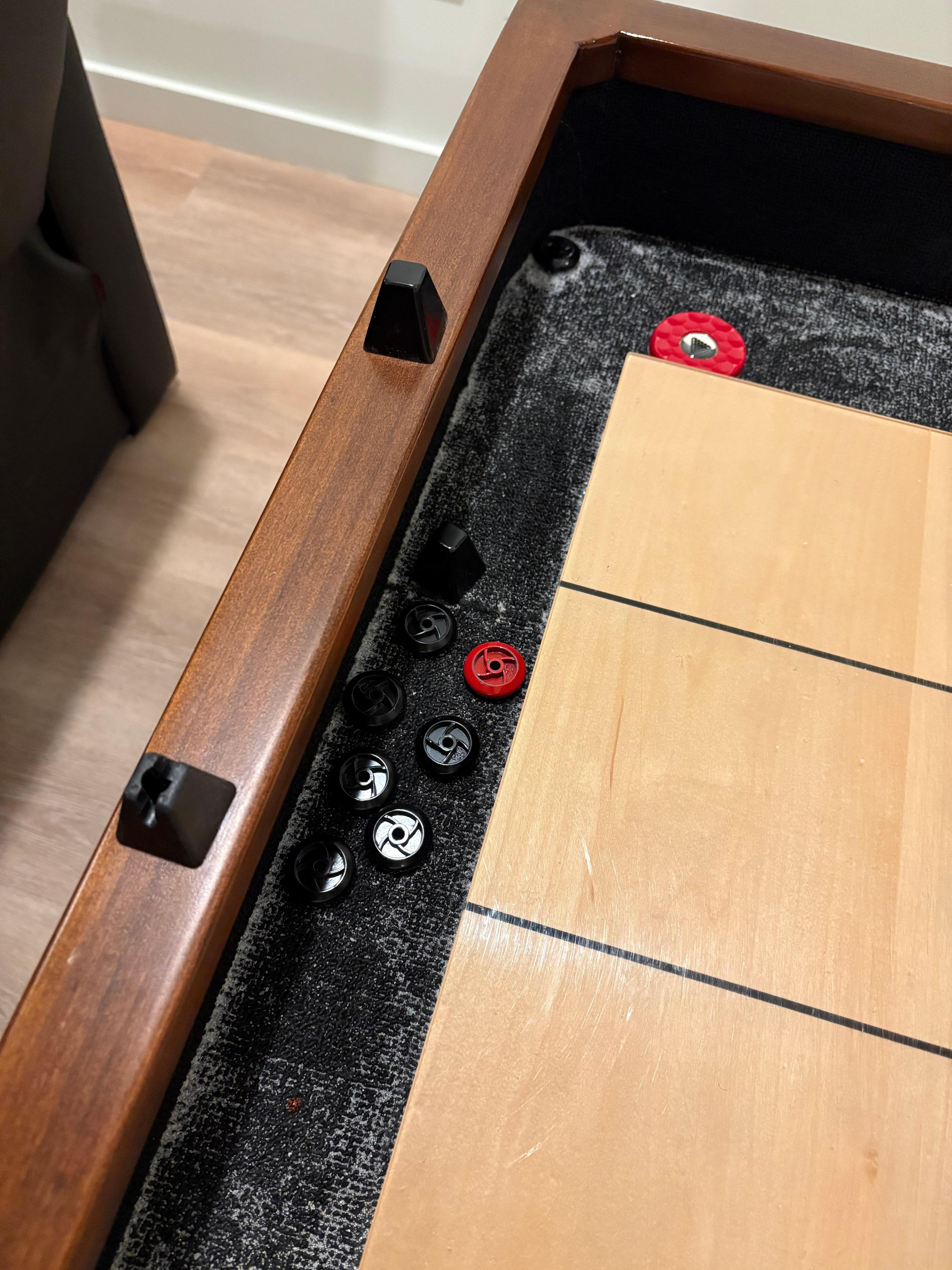 Broken shuffle board score markers.