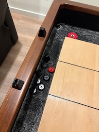 Broken shuffle board score markers.