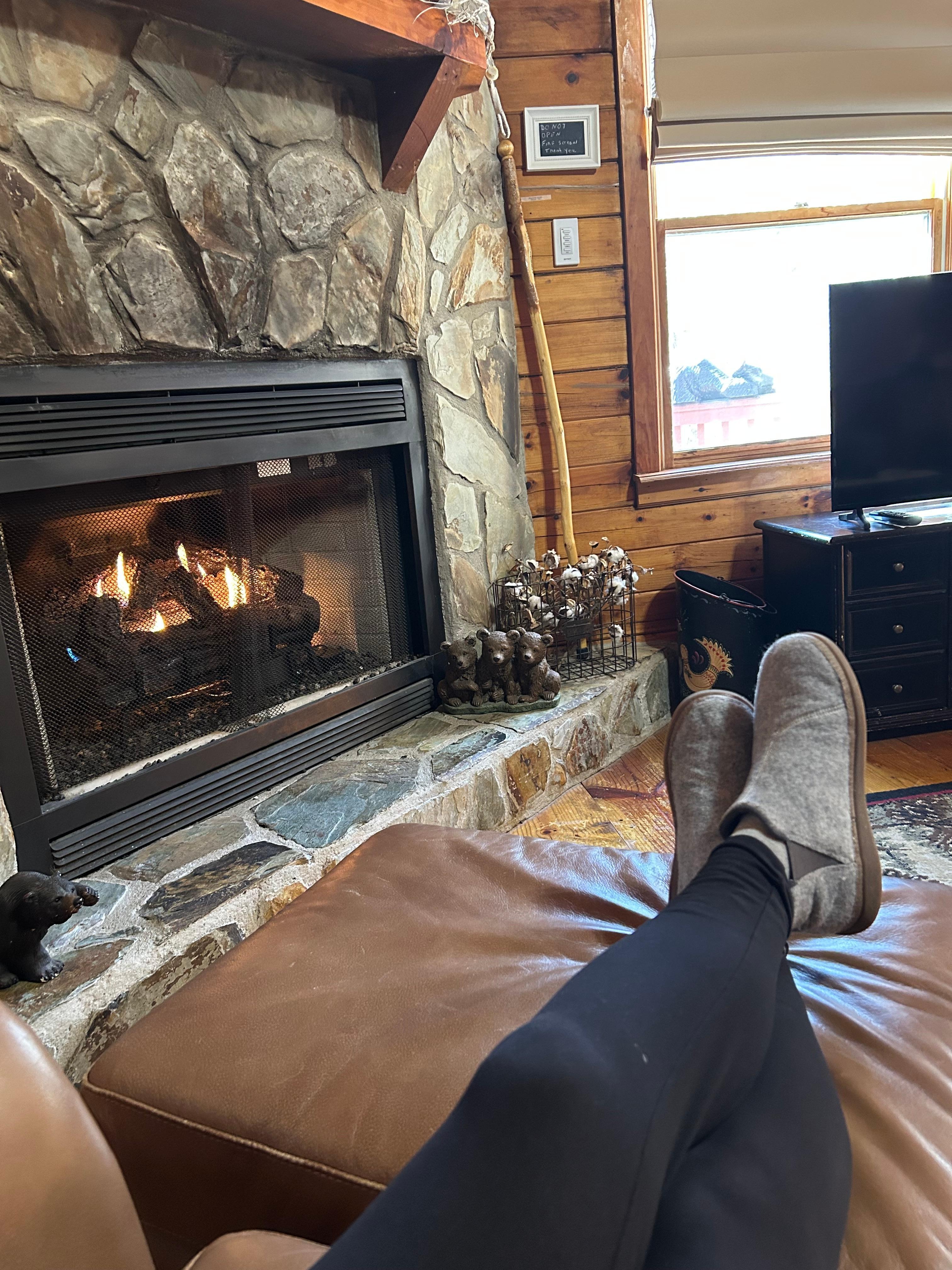 Relaxing by the fireplace in a comfy chair